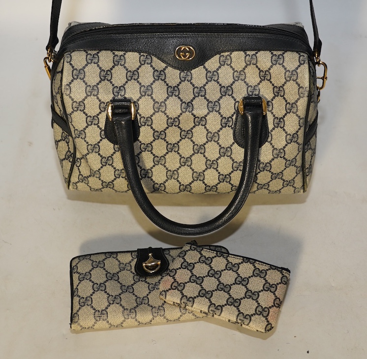 A Gucci monogram blue canvas handbag, wallet and purse